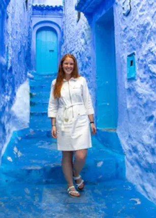 A study abroad student walking through the Blue City in Morocco